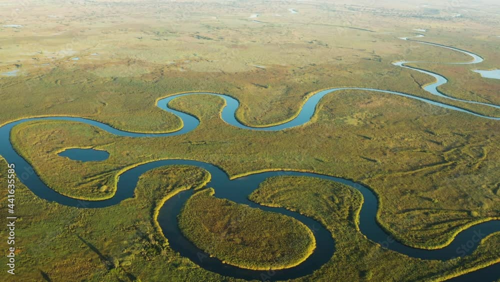 Spectacular aerial fly over view of the beautiful scenic curving patterned waterways and lagoons of the Okavango Delta