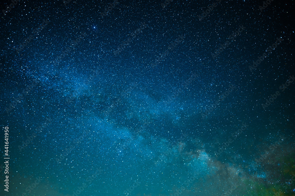 Fototapeta premium Milky Way. Starry night sky. Beautiful landscape. The majesty of nature. Starry silence and silence. Various shades of blue. Small stars twinkle in the night sky.