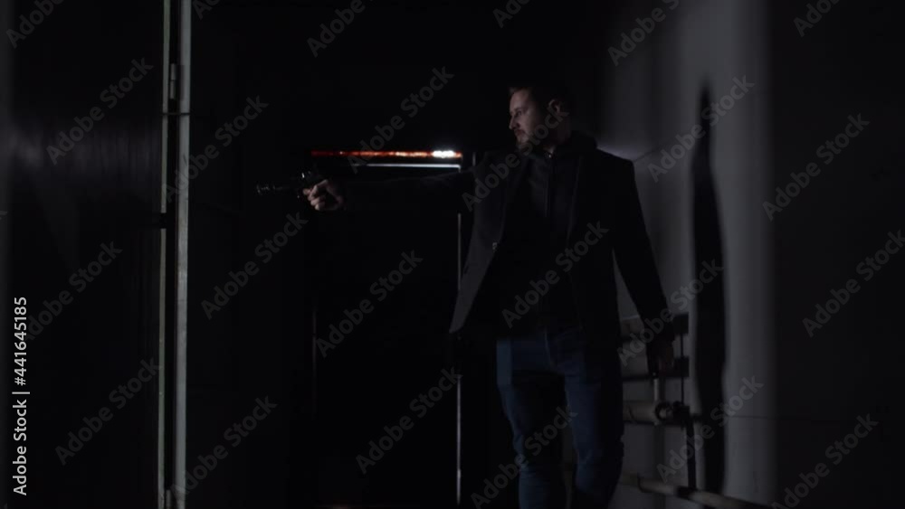 Dangerous badass man shooting from a gun and pulls the shutter Dangerous badass man shooting from a gun and pulls the shutter