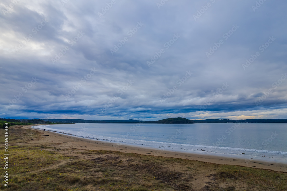 Rain clouds and aerial reverse sunset seascape at Corrigans Beach
