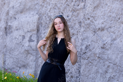 Canvas Print Medium horizontal view of beautiful teenaged girl dressed in a black summer dres