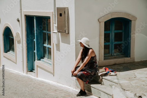 A female tourist rests after a long trip  in beautiful city of Malia. © Dan Chis