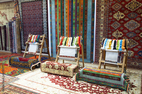 caucasian woman Weaving carpet with traditional techniques on a loom. Wool yarns used as a warp and weft is crucial for this art 