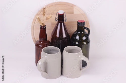 Beer bottles of different sizes and beer ceramic mugs empty mockup on white background.copy space for text.Packaging template design concept.