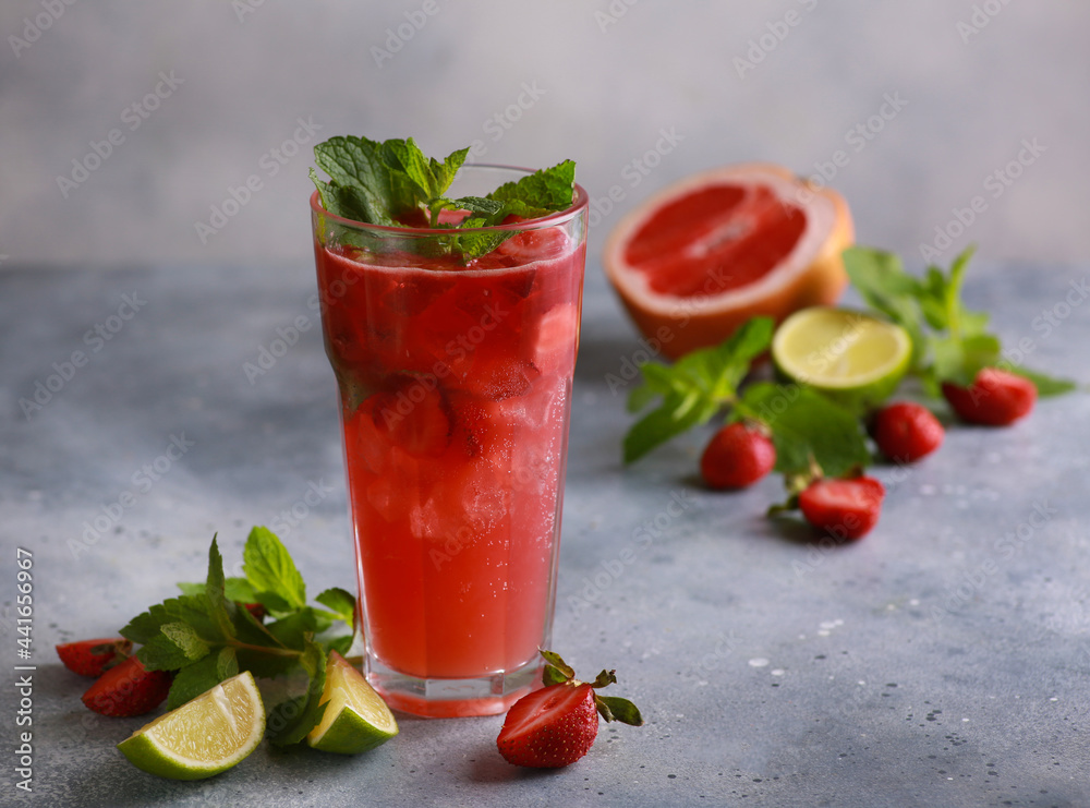 Summer. Soft drinks. Strawberry mojito with ice and mint, grapefruit and lime on a light gray background. Background image, copy space Summer. Soft drinks. Strawberry mojito with ice and mint, grapefruit and lime on a light gray background. Background image, copy space