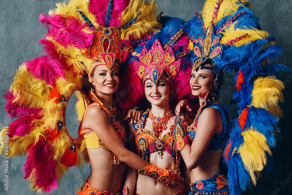 Three Women dancers in brazilian samba carnival costume with colorful  feathers plumage. Stock Photo