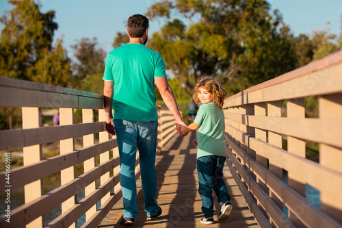 Dad and child playing outdoors. Happy family. Men generation. © Volodymyr