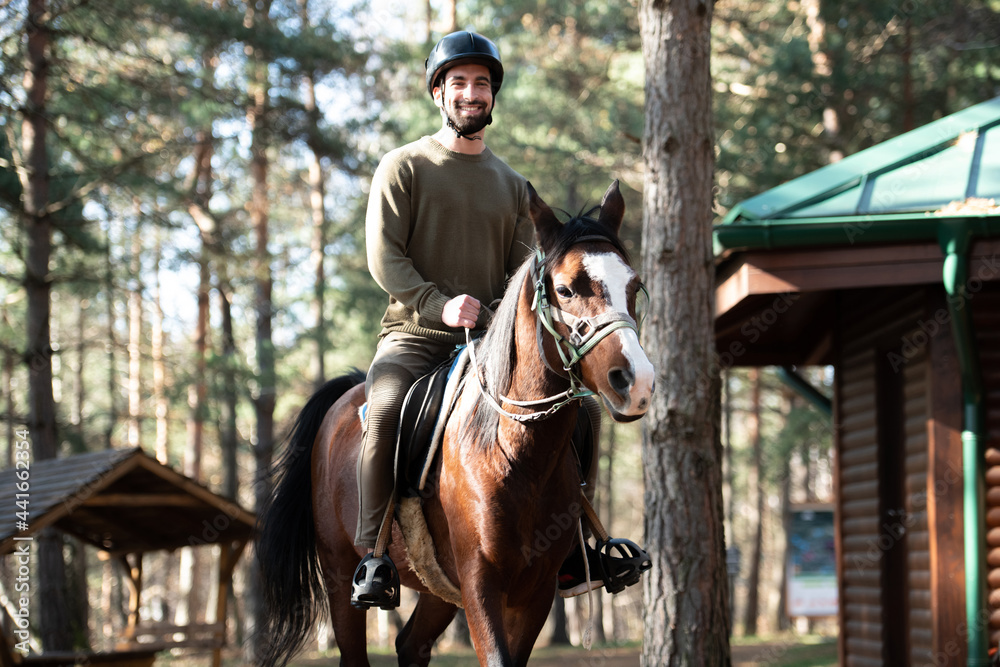 Man With Helmet Riding a Horse in Forest