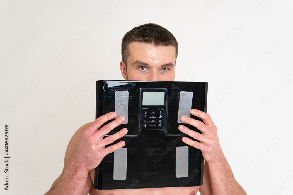 Man with weights health pondered, health and sports on a white background sore injury, ill caucasian young adult, hand holding. Hold therapy, disease suffer attractive