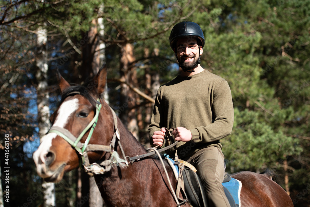 Man With Helmet Riding a Horse in Forest