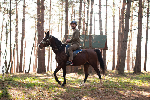 Young Man Rides a Horse Wearing a Helmet © Jale Ibrak