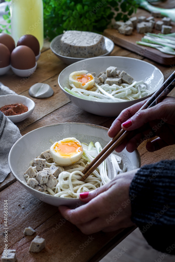 Anonymous person preparing ramen soup with chopsticks Anonymous person preparing ramen soup with chopsticks