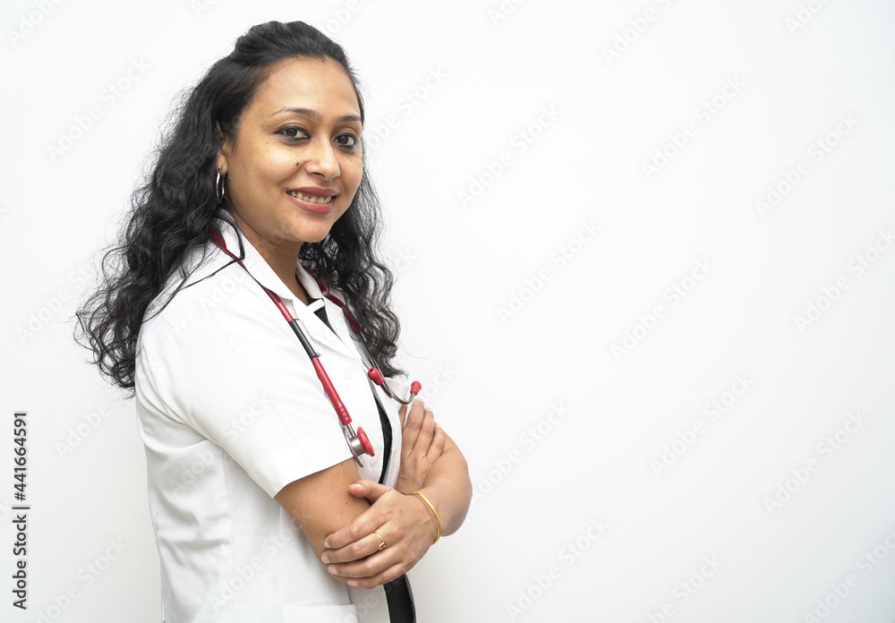 A south Indian female doctor in 30s with white coat and red stethoscope in white background A south Indian female doctor in 30s with white coat and red stethoscope in white background