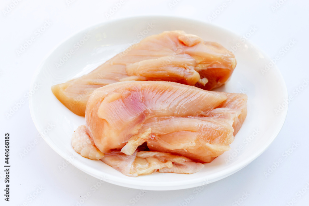 Uncooked raw chicken breast fillets on white background. Uncooked raw chicken breast fillets on white background.