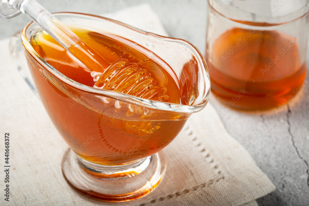 Honey in glass bowl on the table. Honey in glass bowl on the table.