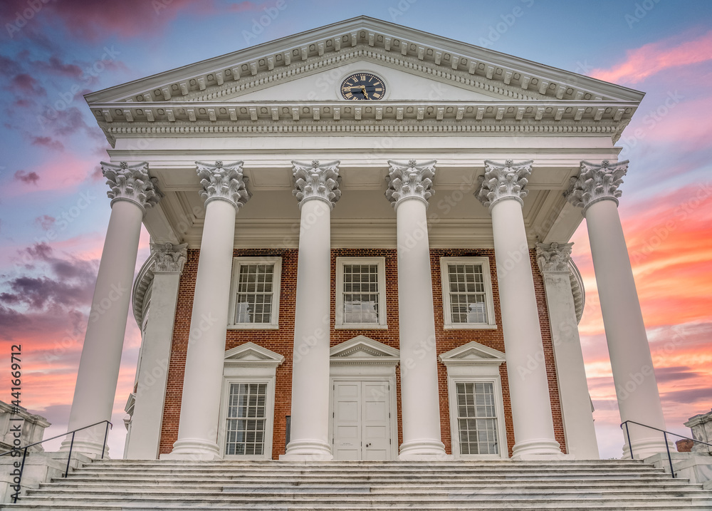 The famous rotunda building of the University of Virginia in Charlottesville with classic Greek arches design by President Jefferson iconic building of the campus with dramatic sunset sky