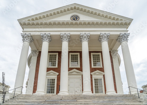 The famous rotunda building of the University of Virginia in Charlottesville with classic Greek arches design by President Jefferson iconic building of the campus with neutral sky photo