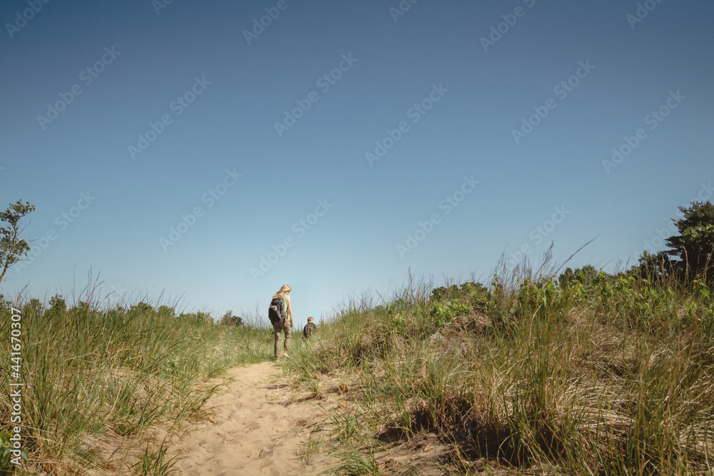 Mother and young son walking along a path at Indiana Dunes State Park Mother and young son walking along a path at Indiana Dunes State Park
