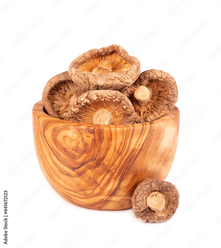 Dried shiitake mushrooms in olive bowl, isolated on white background. Japanese forest mushroom. Lentinula edodes. Close up. Dried shiitake mushrooms in olive bowl, isolated on white background. Japanese forest mushroom. Lentinula edodes. Close up.