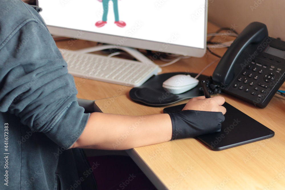 Hand of a draftsman with a graphic tablet with the computer Hand of a draftsman with a graphic tablet with the computer