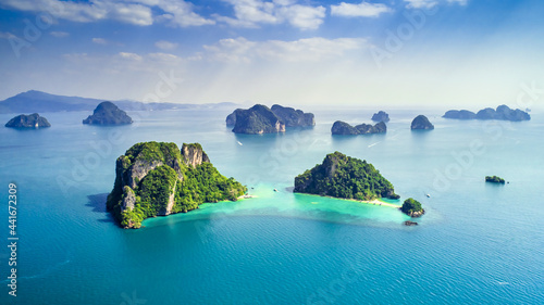 Surrounding Islands of Koh Yao Noi, Phuket, Thailand green lush tropical island in a blue and turquoise sea with islands in the background and clouds with sun beams shining through, drone aerial photo © Huw Penson