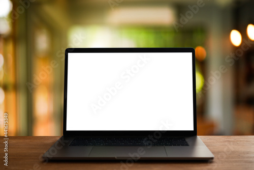laptop on the table,office background for light bokeh. 