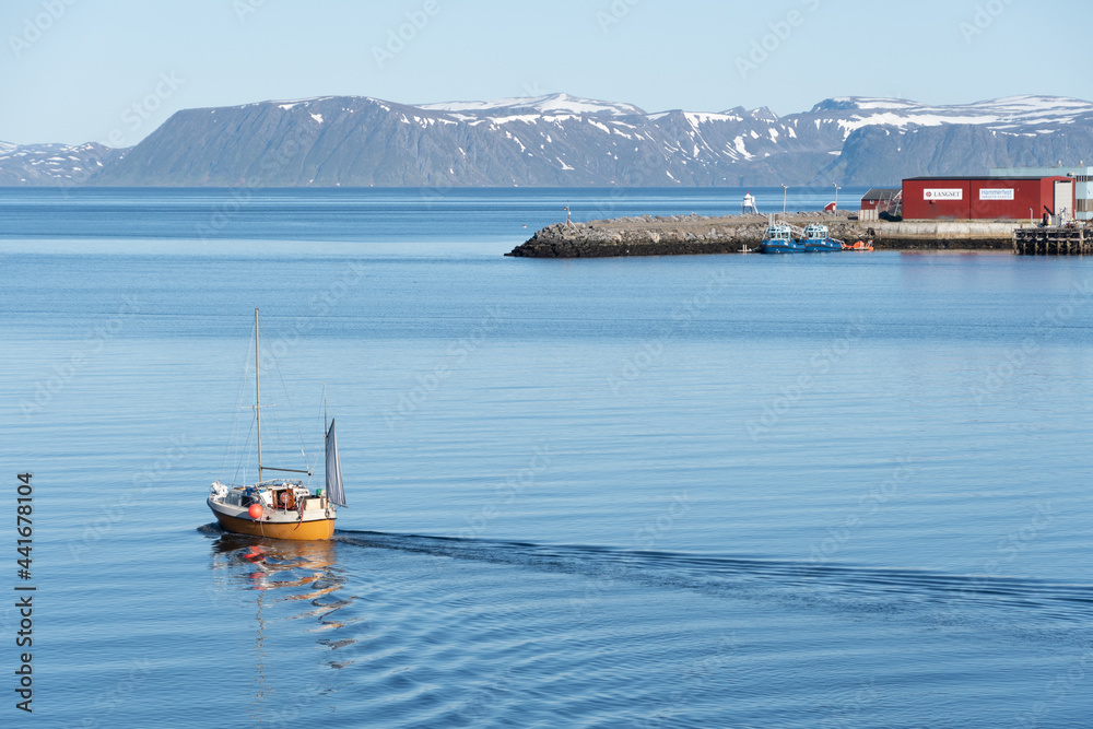 A sailboat leaving harbor in Northern Norway.