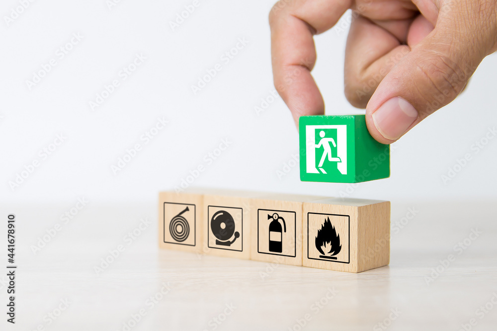 Fire exit, Close-up hand choose wooden toy block stack with door exit ...