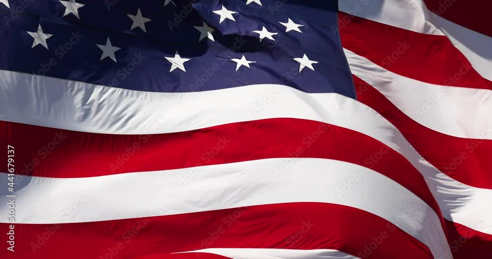 4k Slow Motion Real American Flag Waving In Wind Against a Deep Blue Sky