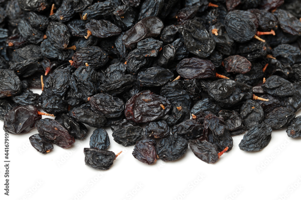 black raisins on a white background black raisins on a white background
