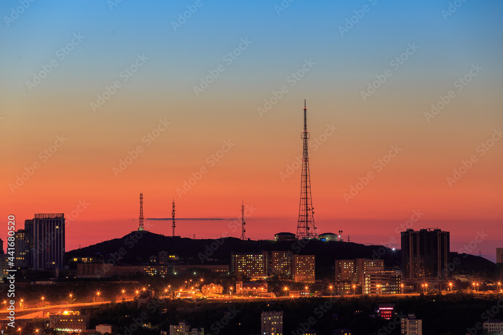 Summer, 2017 - Vladivostok, Russia - Television tower during a bright sunset in Vladivostok. View of the central hill of a large sea city.