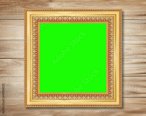 The antique gold frame on wooden wall background , for Graphics design.