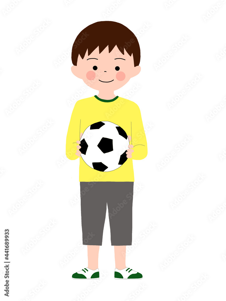 a boy standing with a ball