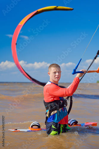 Photography Kiteboarder surfing waves with kiteboard on a sunny summer day.