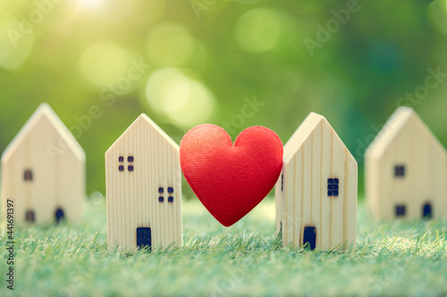 Fotografie Love heart between two house wood model for stay at home for healthy community together on green fresh ecology natural environment