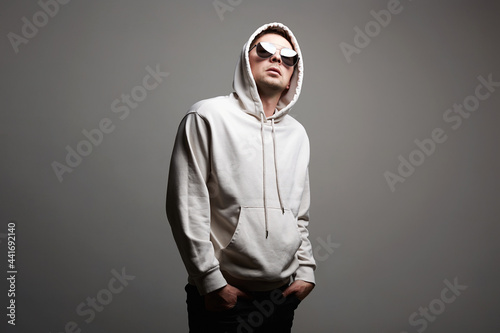 Man in Hood and sunglasses. stylish Boy in a hooded sweatshirt
