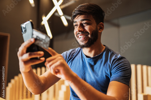 Young man online banking using smartphone shopping online with credit card at balcony of your home lifestyle. © Brastock Images