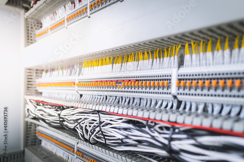 Wiring PLC Control panel with wires industrial factory.Wiring terminals in the electrical Cabinet. Electrical wires or cables are connected to electrical equipment