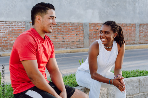 young male and female couple chatting after exercising