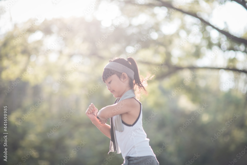 happy child girl running in the park in summer in nature. warm sunlight flare. asian little is running in a park. outdoor sports and fitness, exercise and competition learning for kid development. happy child girl running in the park in summer in nature. warm sunlight flare. asian little is running in a park. outdoor sports and fitness, exercise and competition learning for kid development.