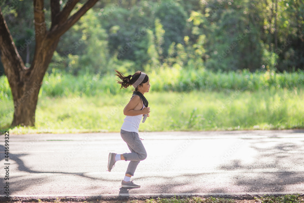 happy child girl running in the park in summer in nature. warm sunlight flare. asian little is running in a park. outdoor sports and fitness, exercise and competition learning for kid development. happy child girl running in the park in summer in nature. warm sunlight flare. asian little is running in a park. outdoor sports and fitness, exercise and competition learning for kid development.