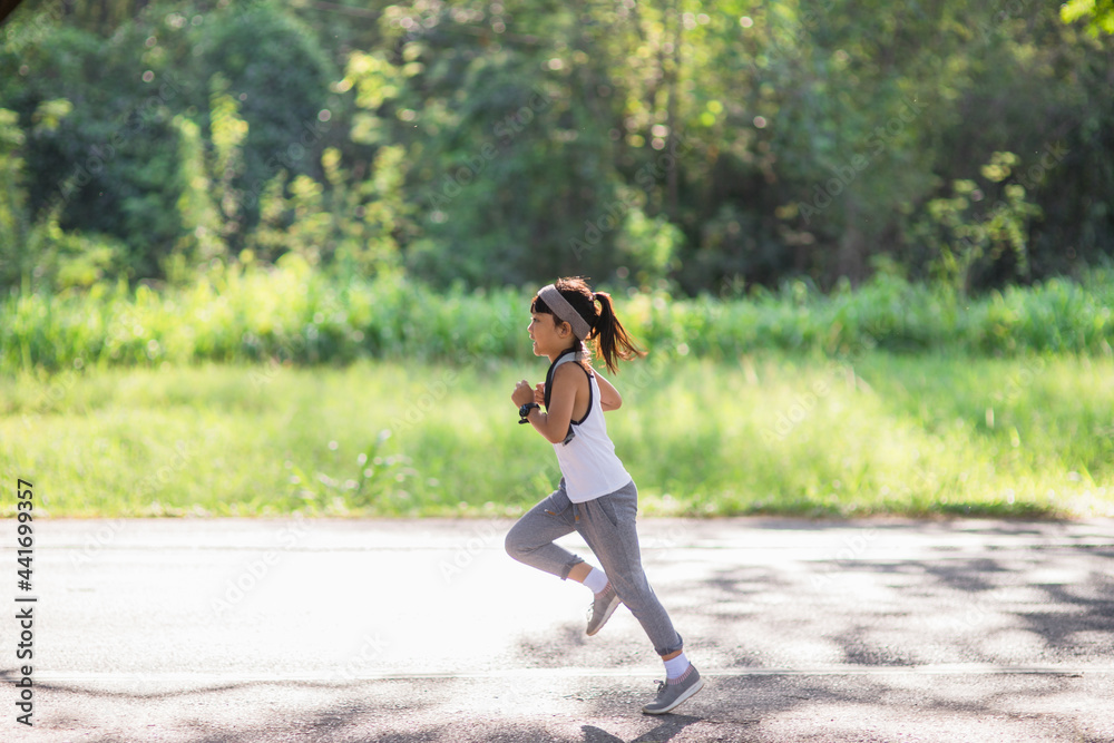 happy child girl running in the park in summer in nature. warm sunlight flare. asian little is running in a park. outdoor sports and fitness, exercise and competition learning for kid development. happy child girl running in the park in summer in nature. warm sunlight flare. asian little is running in a park. outdoor sports and fitness, exercise and competition learning for kid development.