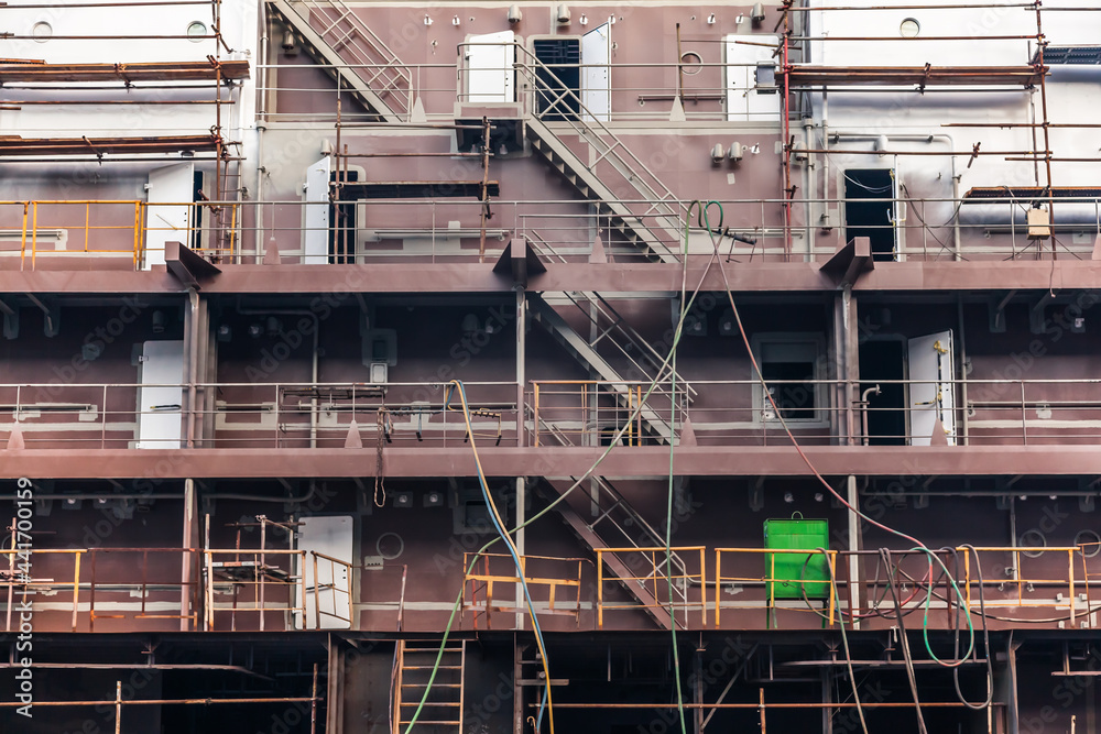 Construction of a new ship hull at the shipyard in Constanta, Romania. Part of the hull of the new ship with scaffolding.