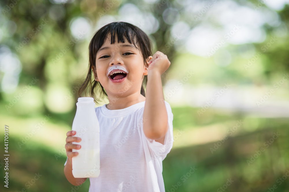 Cute asian little child girl is drinking a milk, soft focus Cute asian little child girl is drinking a milk, soft focus