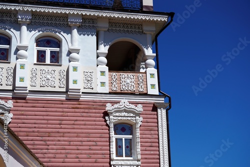 ornate vintage facade of old house in countryside by clear sky