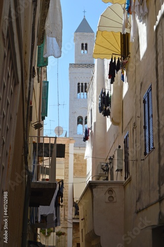 Bari  Italy.Narrow italian street with drying linen and Cathedral on the background.