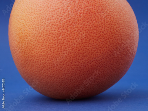 ripe juicy grapefruit on an isolated blue background. a natural product. copy space