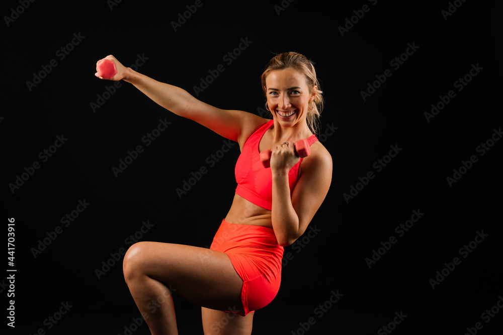 Sporty girl doing exercise with dumbbells, silhouette studio shot over dark and whitebackground Sporty girl doing exercise with dumbbells, silhouette studio shot over dark and whitebackground