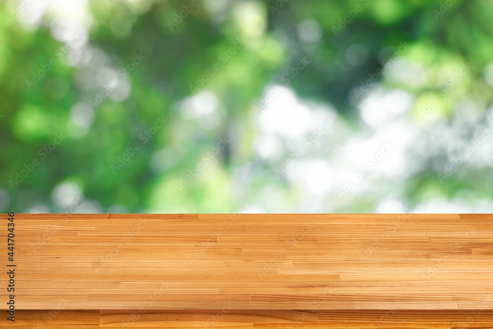 wood table on blurred green bokeh light background wood table on blurred green bokeh light background