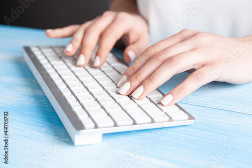 young woman writes on the keyboard